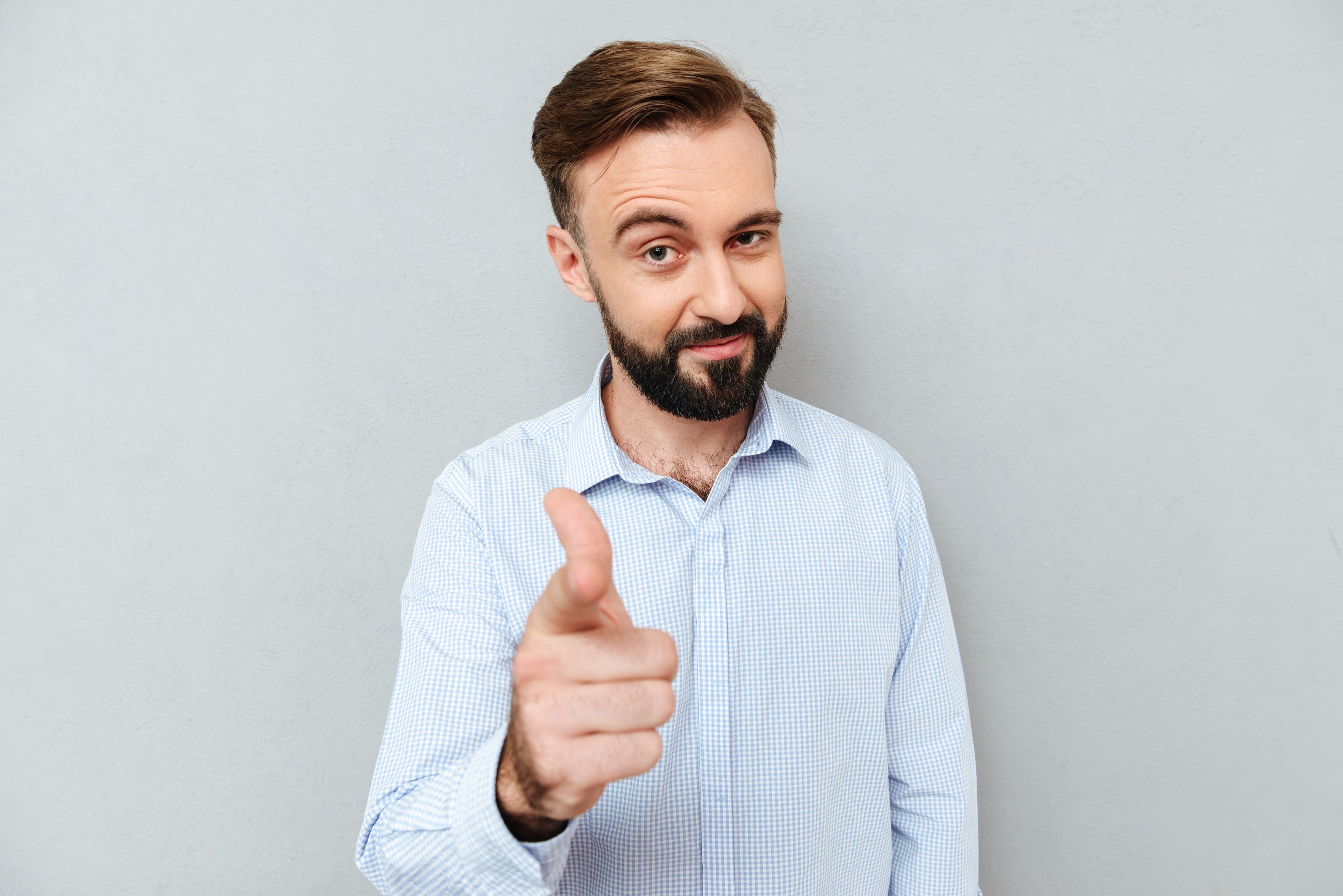 image sly-smiling-bearded-man-business-clothes-pointing